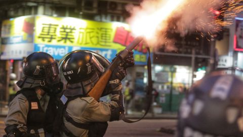 Riot police fire tear gas towards pro-democracy protesters during a stand-off in the Wan Chai district in Hong Kong on August 11, 2019. 