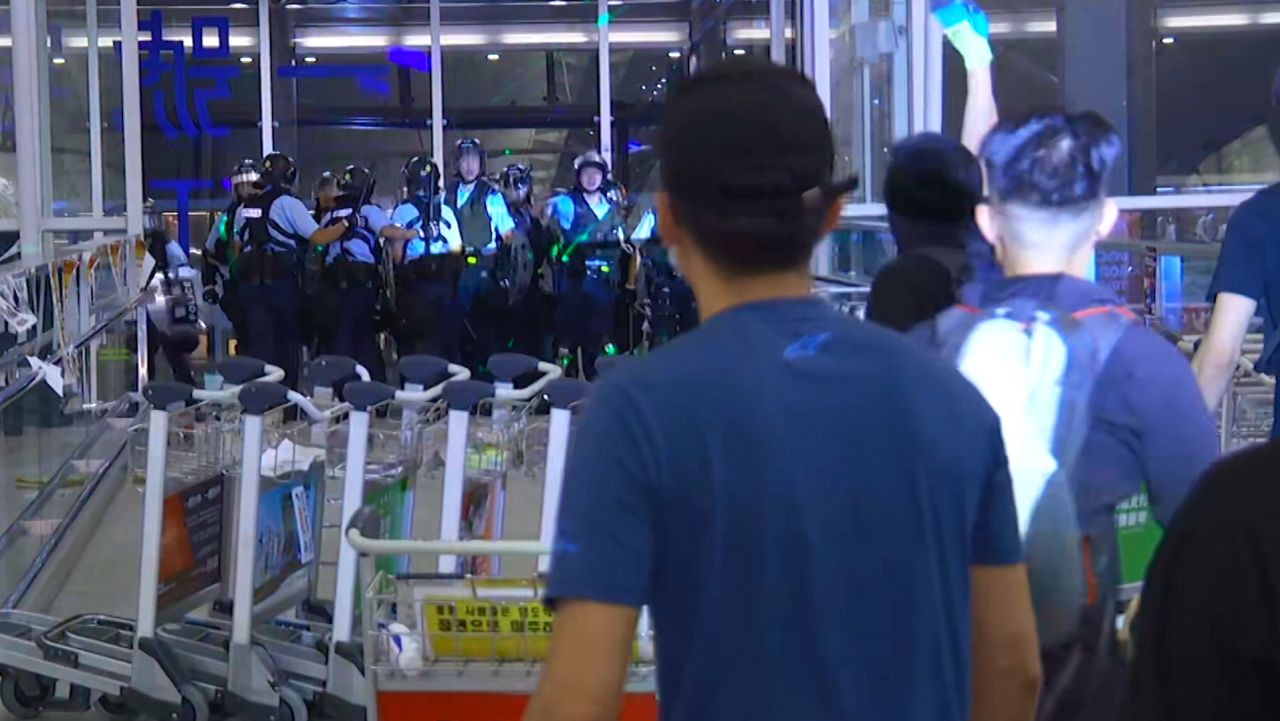 hong kong airport protesters police clash