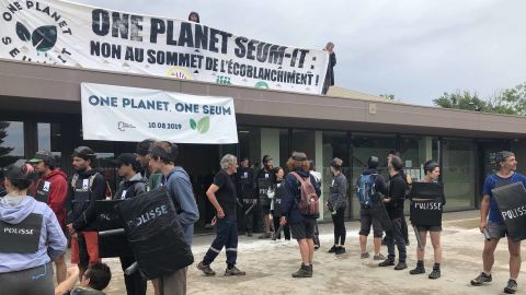 Activists simulate a disruption to a climate summit.