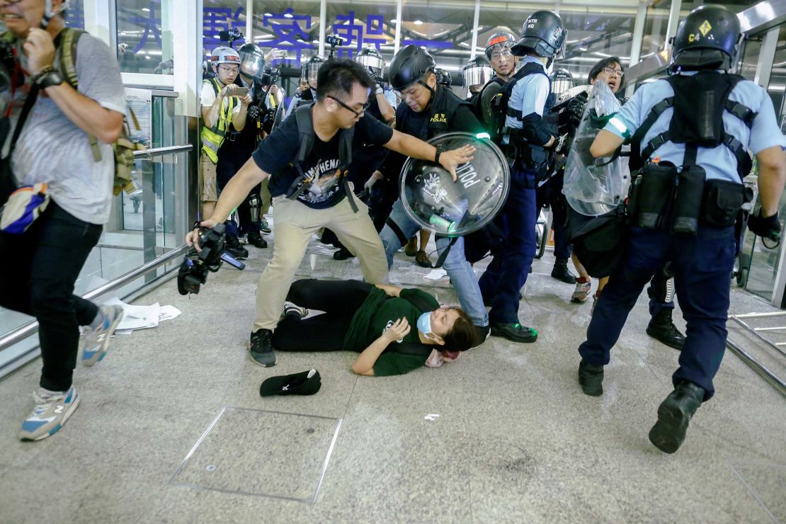 Officers and protesters clash at the airport on Tuesday night.