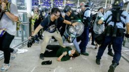 Riot police use pepper spray to disperse anti-extradition bill protesters during a mass demonstration after a woman was shot in the eye, at the Hong Kong International Airport on August 13, 2019. 