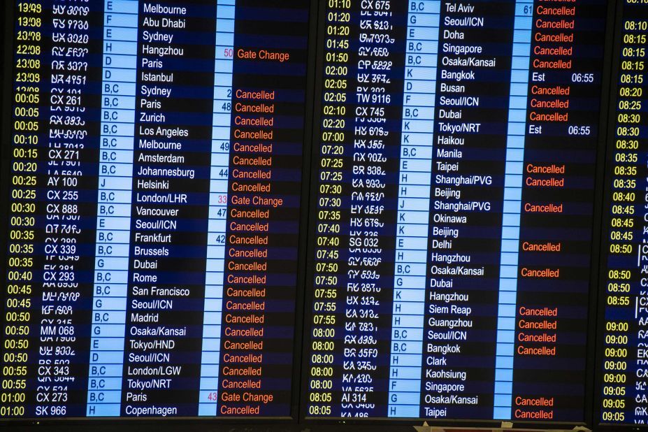 A display board shows canceled flights on August 13.