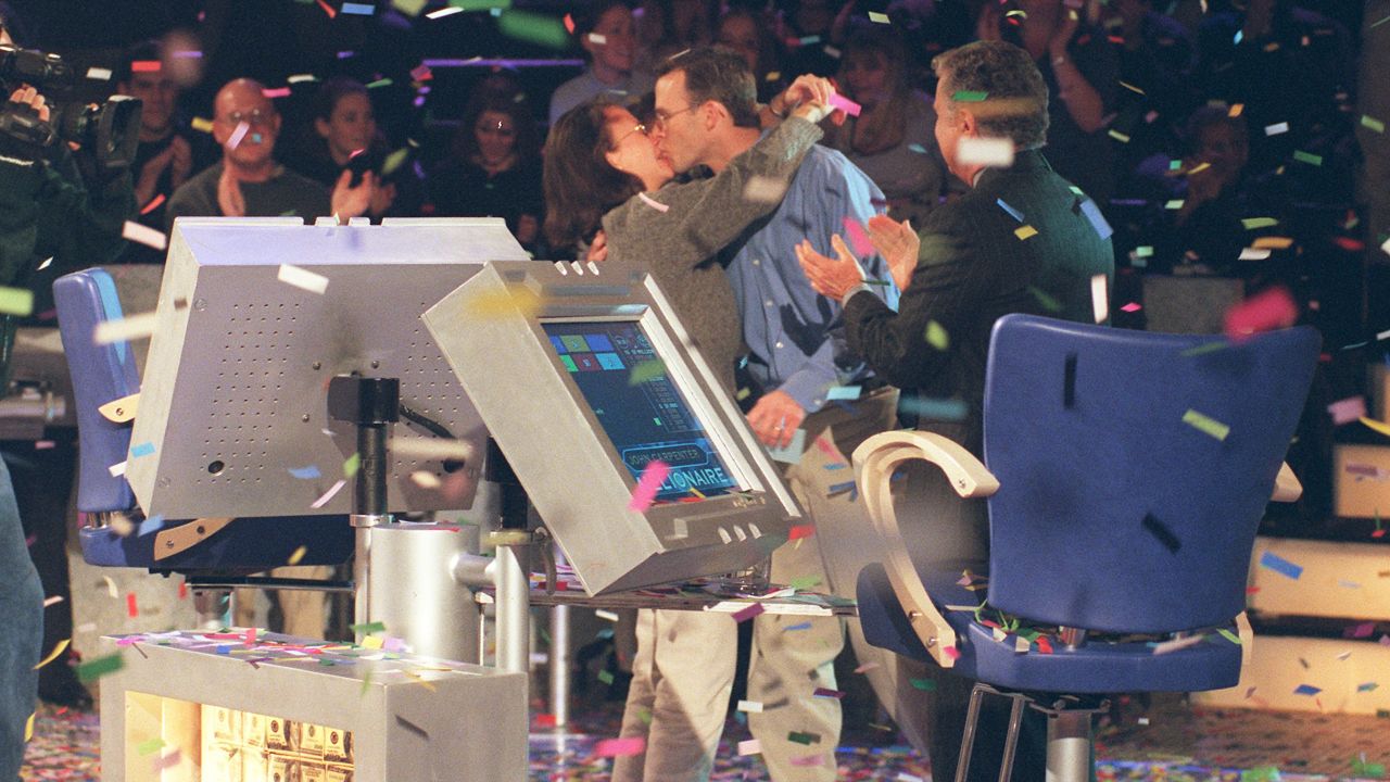 Contestant John Joh John Carpenter (kissing his wife, Debbie) became the first $1 million dollar winner on the show in 1999. (Photo by Maria Melin/Walt Disney Television via Getty Images)
