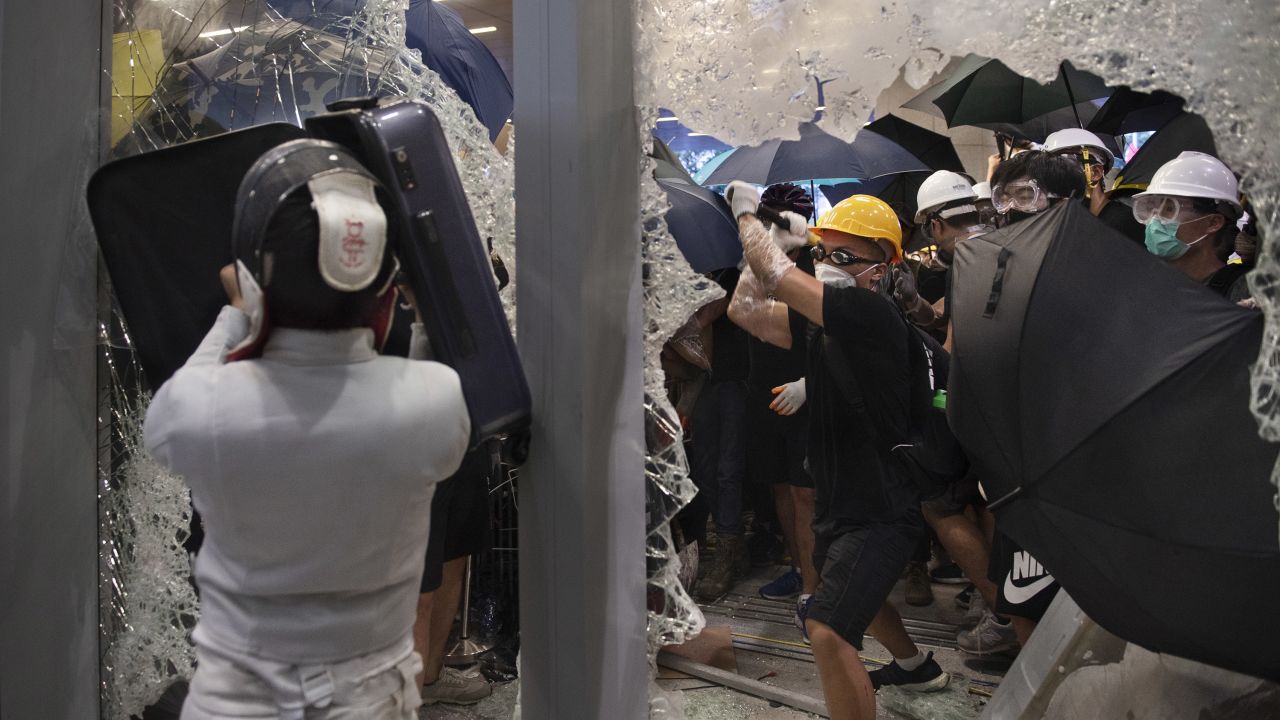 Protesters shatter glass to get inside the Hong Kong's legislature building during a demonstration on July 1, 2019. 