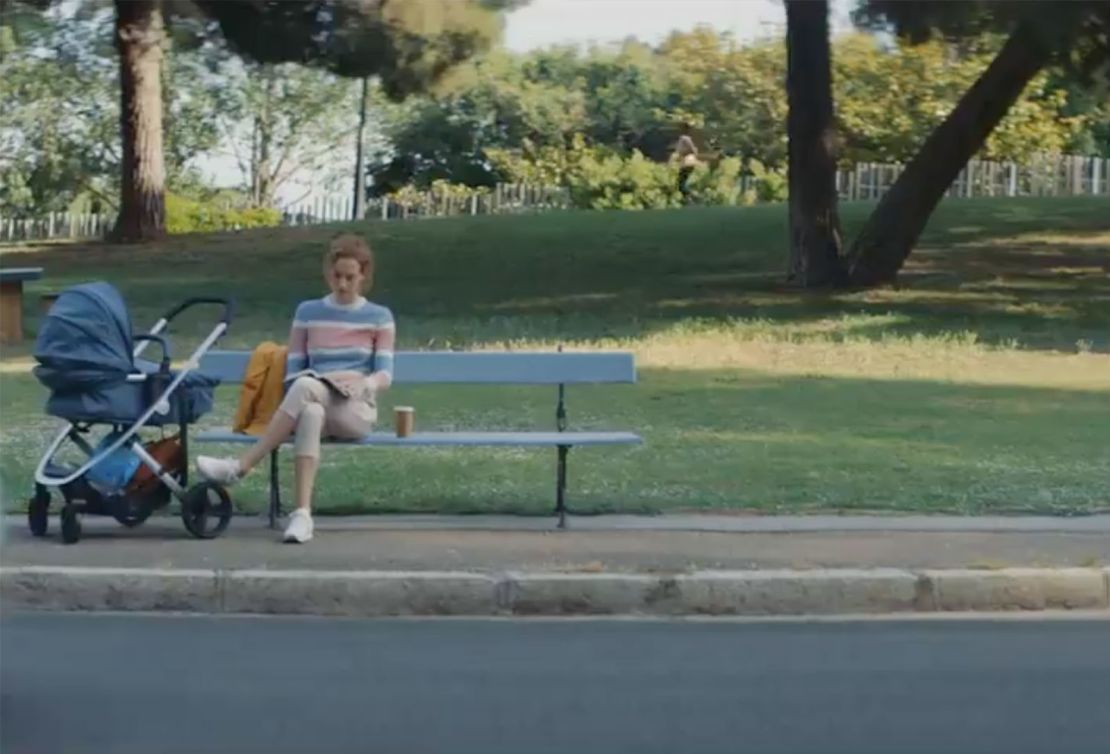 In the Volkswagen ad, a woman is shown sitting by a stroller.