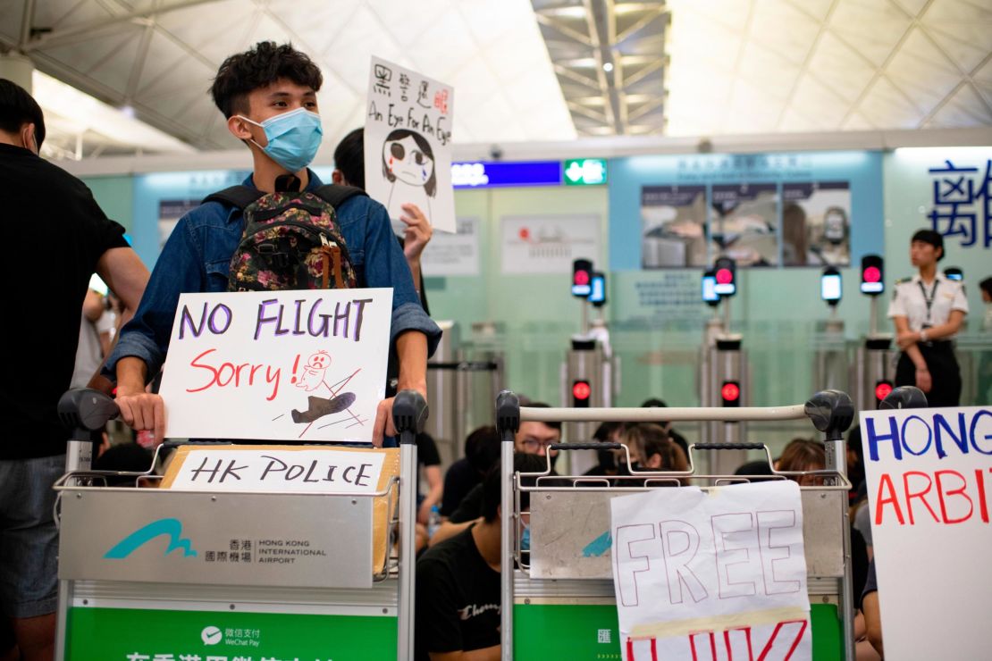 Protesters at Hong Kong International Airport block the entrance to the security checkpoint on Tuesday, August 13.