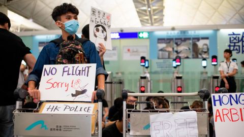 Protesters at Hong Kong International Airport block the entrance to the security checkpoint on Tuesday, August 13.
