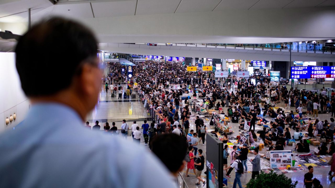 Protesters seen at the arrivals hall of Hong Kong International Airport on Tuesday evening.