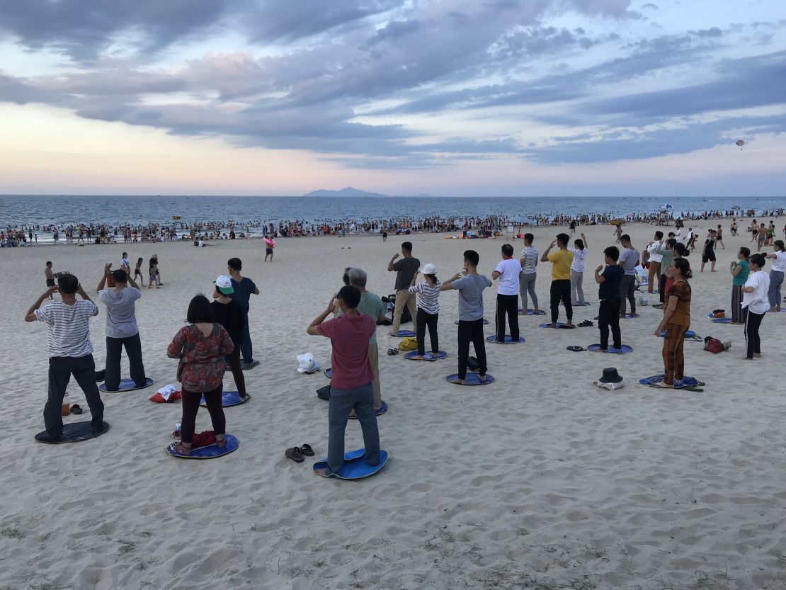 Locals gather for a tai chi and swimming on My Khe beach in Da Nang, Vietnam. During the Vietnam War, the Americans called this China Beach.