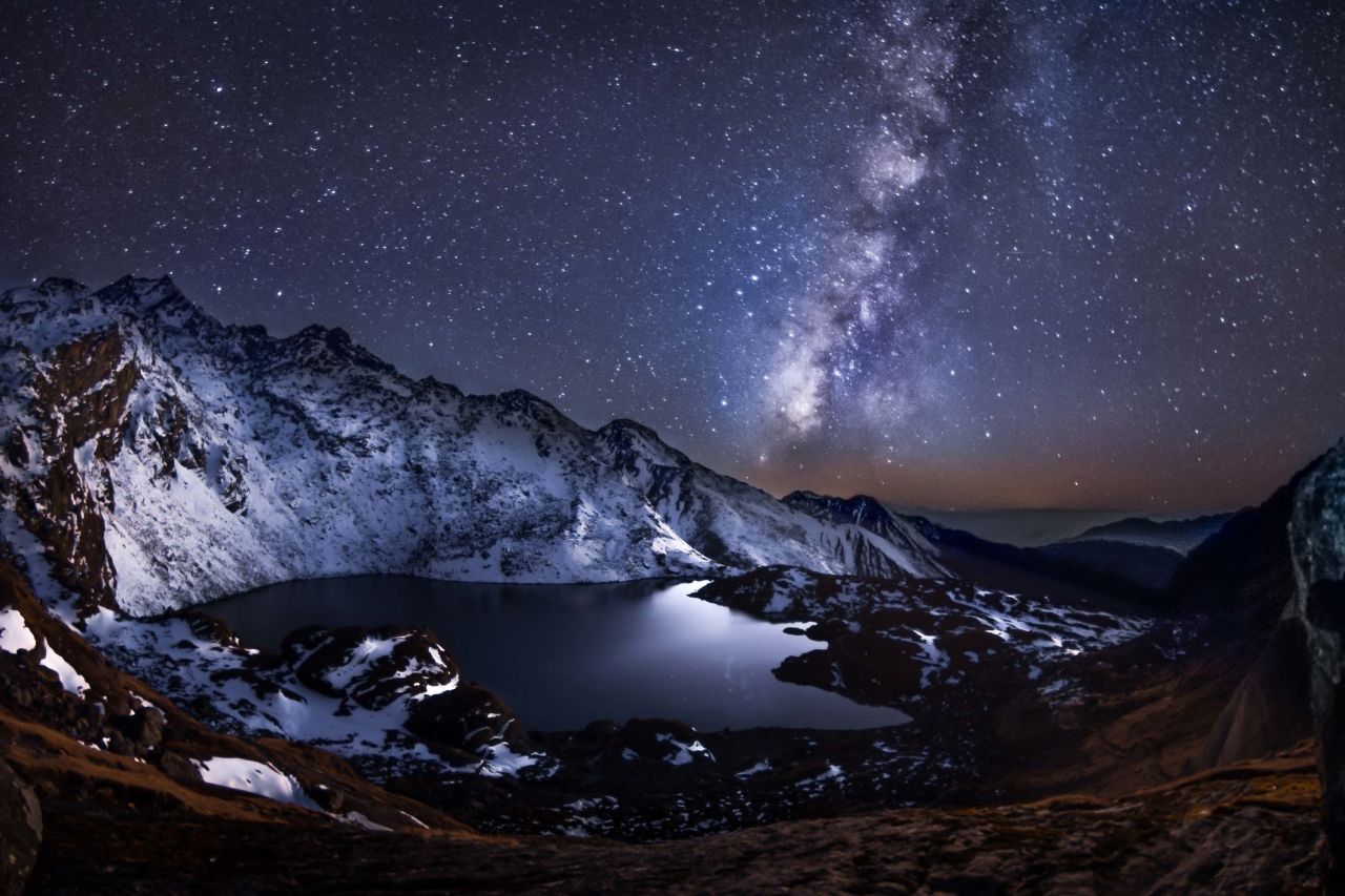 Calmness of Eternity by Yevhen Samuchenko was taken in the Himalayas in Nepal at Gosaikunda lake at 4,400m. The Milky Way is the galaxy that contains the Solar System, with the name describing the galaxy's appearance from Earth: a hazy band of light seen in the night sky formed from stars that cannot be individually distinguished by the naked eye.