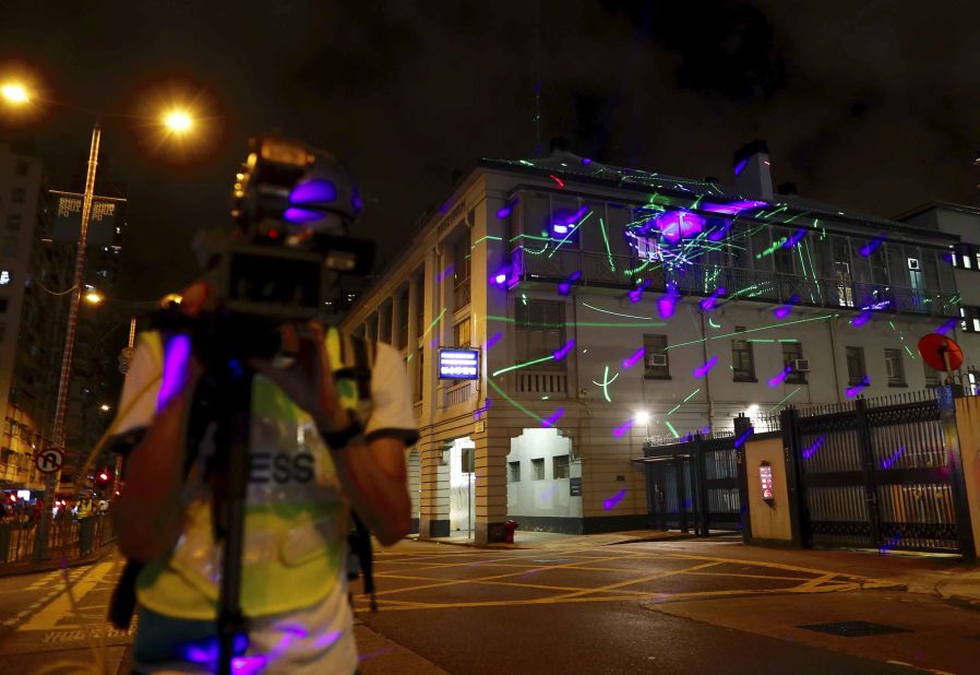 Protesters point lasers at the Sham Shui Po police station on August 14.