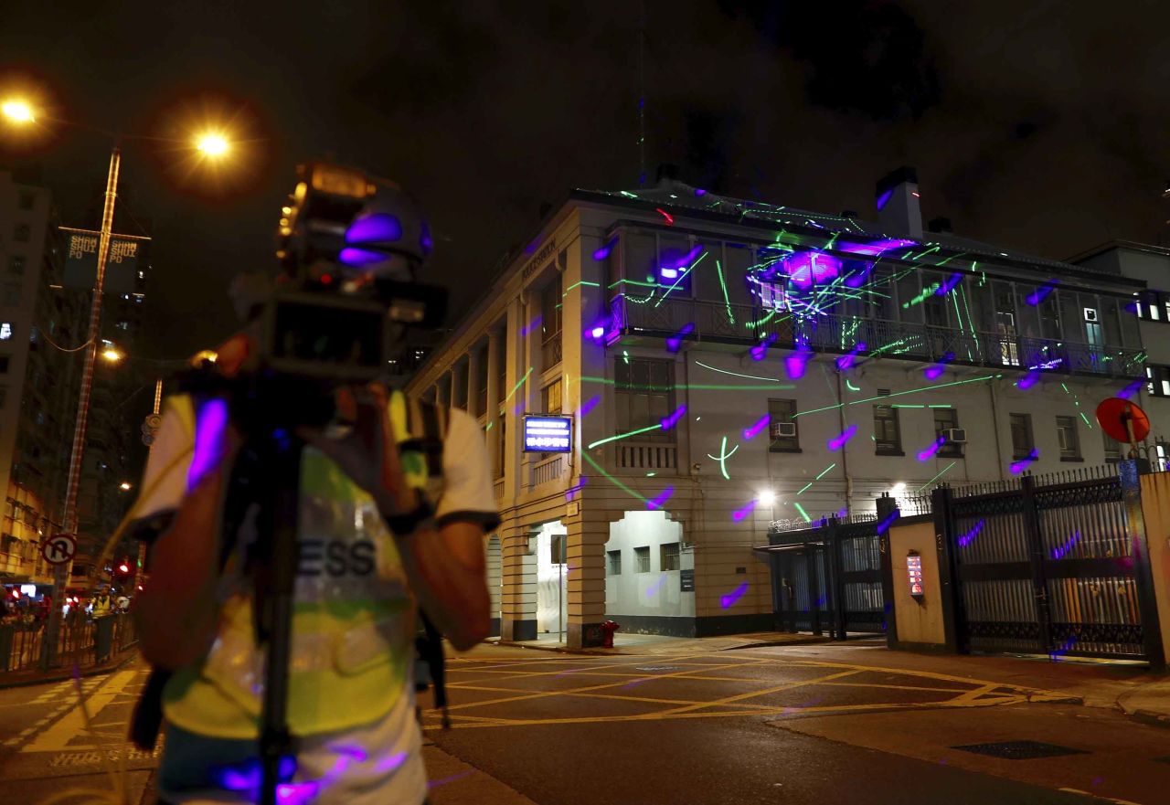 Laser beams shone by protesters light up the Sham Shui Po police station in Hong Kong on August 14, 2019. 