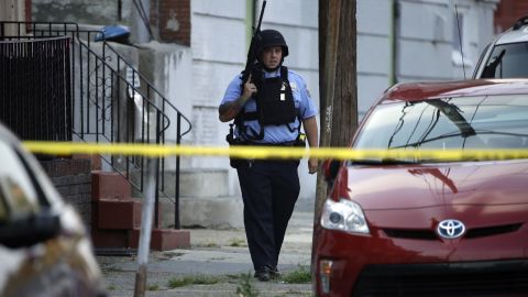 A police officer patrols the block near the shooting scene in Philadelphia on Wednesday.