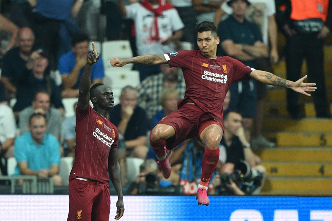 Liverpool's Sadio Mane, left, celebrates after scoring a goal with teammate Roberto Firmino.
