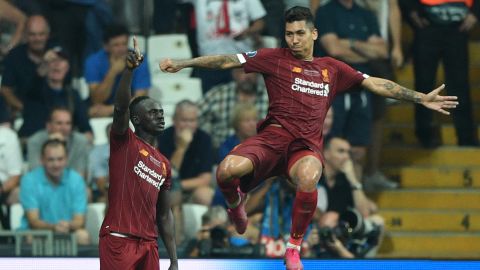 Liverpool's Sadio Mane, left, celebrates after scoring a goal with teammate Roberto Firmino.