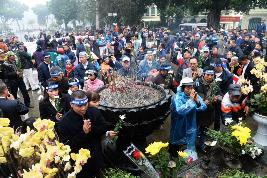 Activists place chrysanthemums and pray during a rally marking the 42nd anniversary of the 1974 naval battle between China and then-South Vietnamese troops over the Paracel Islands, in Hanoi on January 19, 2017.
