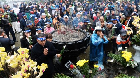 Activists place chrysanthemums and pray during a rally marking the 42nd anniversary of the 1974 naval battle between China and then-South Vietnamese troops over the Paracel Islands, in Hanoi on January 19, 2017.
