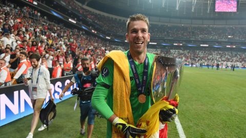 Liverpool's Adrián celebrates with the UEFA Super Cup trophy.