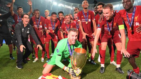Adrián celebrates with his Liverpool teammates.