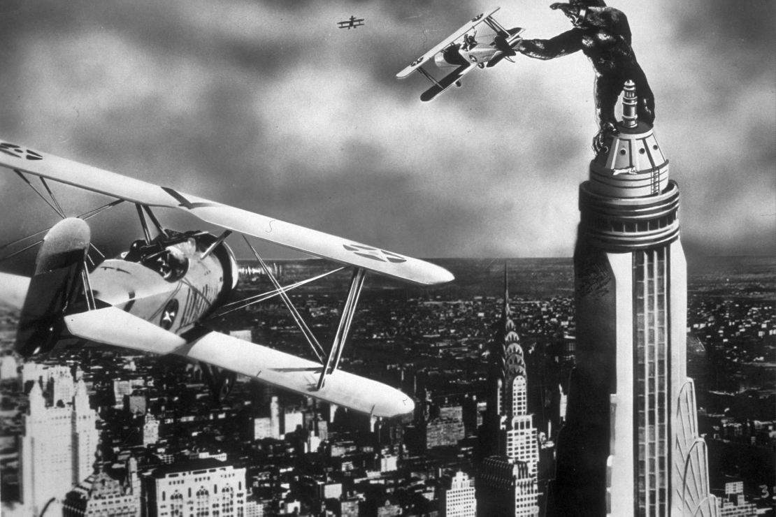 A scene from the film 'King Kong' with the giant gorilla astride a Manhattan skyscraper grabbing a passing aeroplane.  (Photo by Hulton Archive/Getty Images)