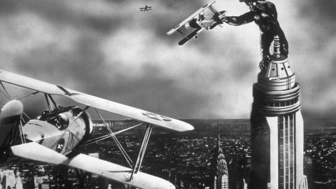 A scene from the film 'King Kong' with the giant gorilla astride a Manhattan skyscraper grabbing a passing aeroplane.  (Photo by Hulton Archive/Getty Images)