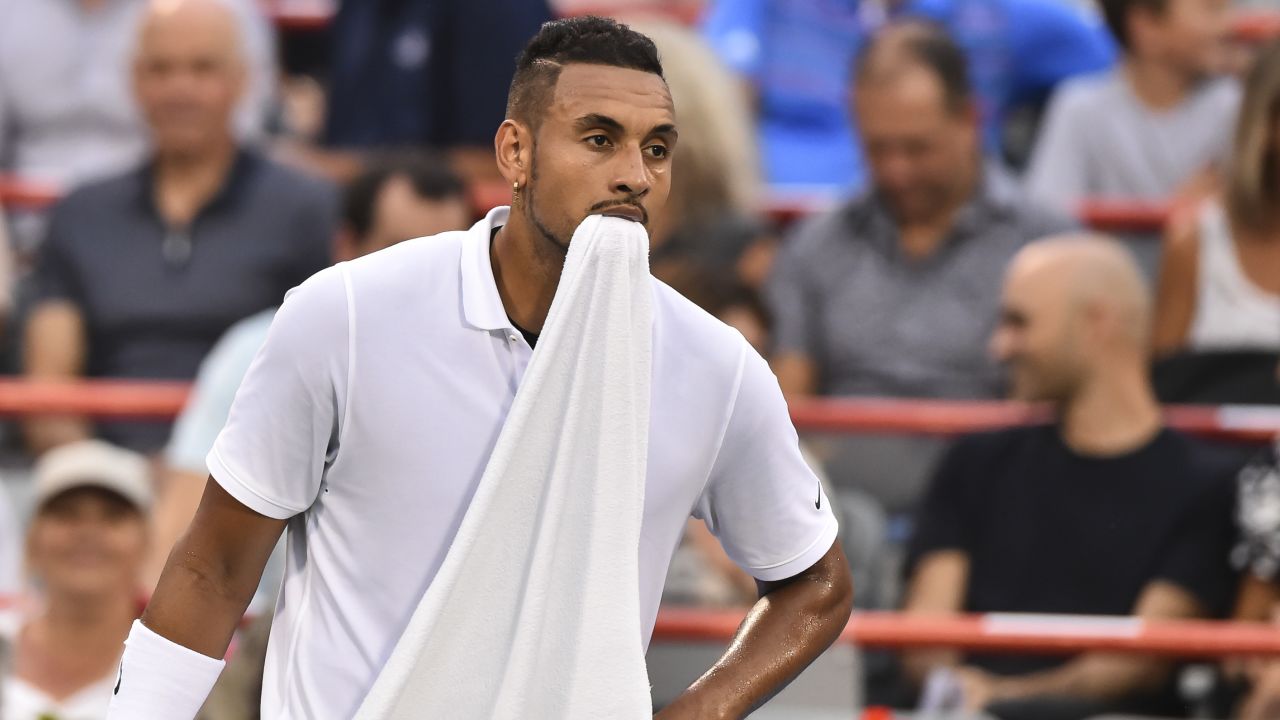 Nick Kyrgios holds his towel in his mouth after losing against Britain's Kyle Edmund in August.