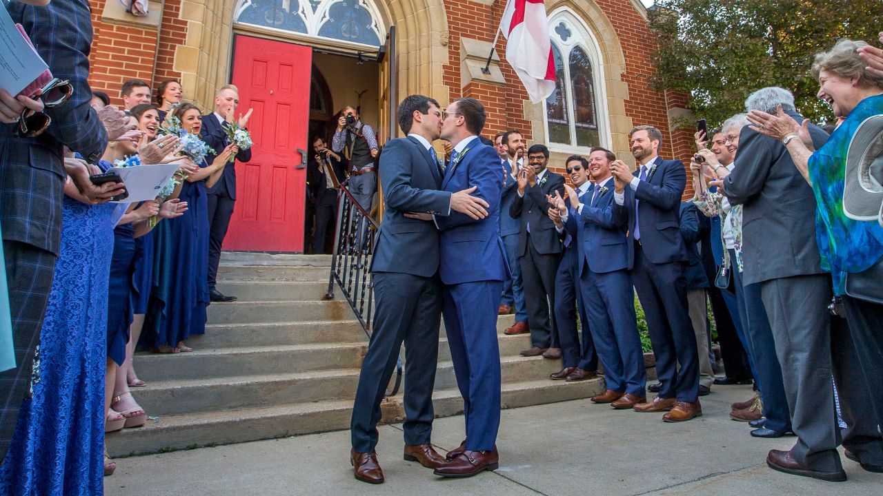 Buttigieg kisses Chasten Glezman following their wedding on June 16, 2018, outside the Cathedral of St. James in South Bend.