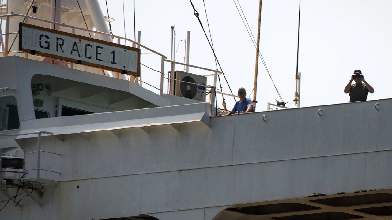 Crew members stand on the Grace 1 supertanker earlier on Thursday.