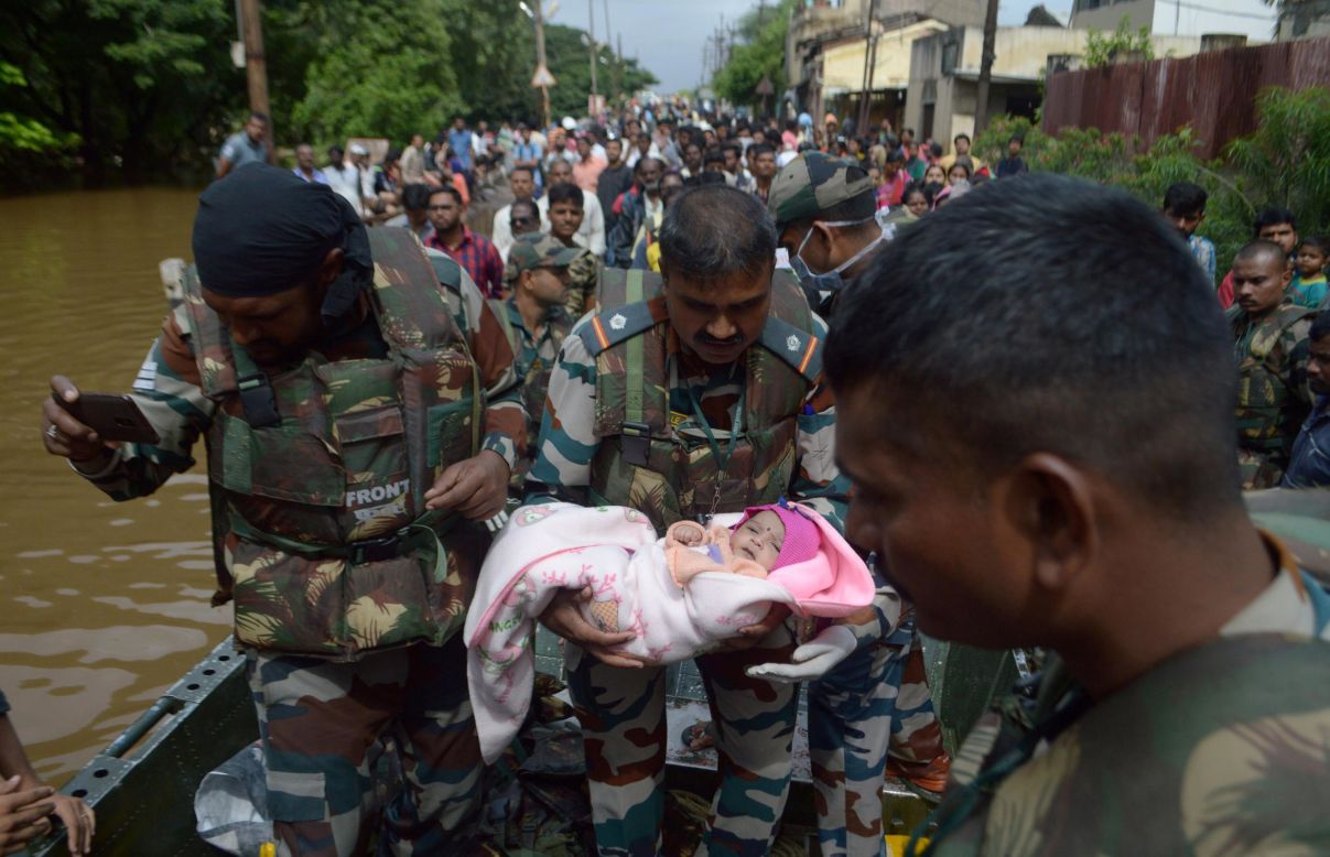 A soldier carries an infant to safety while a flooded area of Sangli, India, is evacuated on Sunday, August 11. Heavy monsoon rains <a href="https://www.cnn.com/2019/08/11/asia/monsoon-india-deaths/index.html" target="_blank">caused devastating landslides and floods</a> that left more than 150 people dead in India, according to local government reports.
