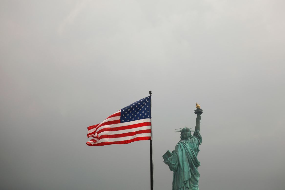 An American flag flies near the Statue of Liberty on Wednesday, August 14. Ken Cuccinelli, the acting director of US Citizenship and Immigration Services, <a href="https://www.cnn.com/2019/08/13/politics/ken-cuccinelli-statue-of-liberty/index.html" target="_blank">revised the words to the statue's iconic poem</a> during <a href="https://www.npr.org/2019/08/13/750726795/immigration-chief-give-me-your-tired-your-poor-who-can-stand-on-their-own-2-feet" target="_blank" target="_blank">an interview</a> with NPR published on Tuesday. When NPR's Rachel Martin asked him if the words "give me your tired, give me your poor" are part of the American ethos, Cuccinelli said they are. "Give me your tired and your poor who can stand on their own two feet and who will not become a public charge," he said, tweaking the famous poem from Emma Lazarus.