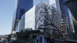 People walk by the new arts center The Shed on the Hudson Yards on April 03, 2019 in New York City. - The Sheds is a movable structure and will be the arts center designed exclusively to commission, produce, and present all types of performing arts, visual arts, and popular culture. (Photo by Kena Betancur / AFP)        (Photo credit should read KENA BETANCUR/AFP/Getty Images)