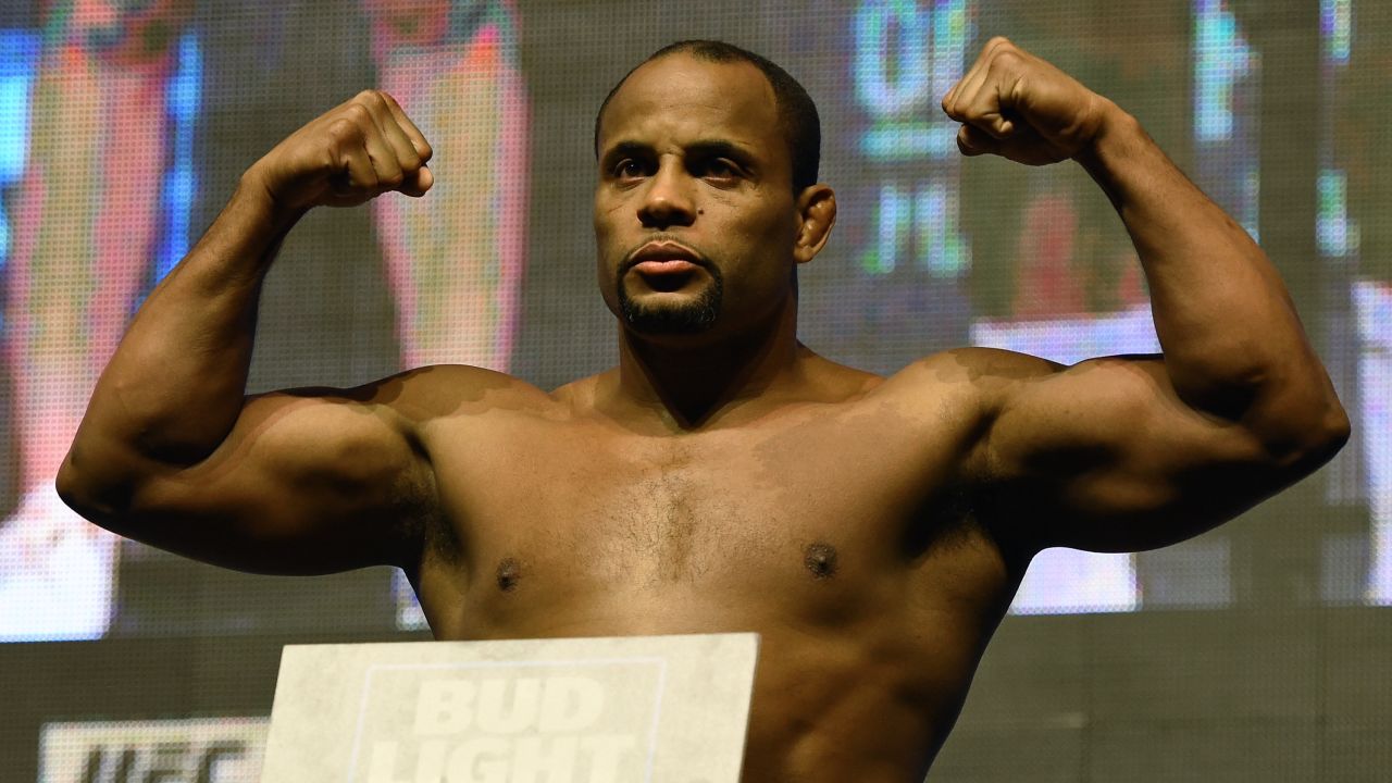 Mixed martial artist Daniel Cormier poses on the scale during his weigh-in for UFC 200