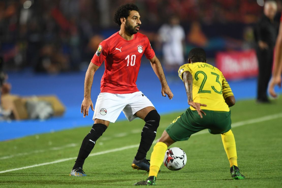 Salah (L) is marked by South Africa's midfielder Thembinkosi Lorch.