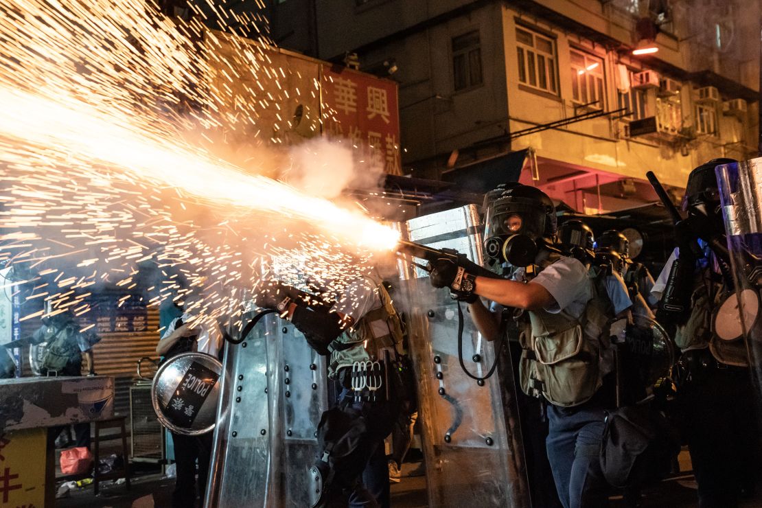 Police fire tear gas to clear pro-democracy protesters during a demonstration on Hungry Ghost Festival day in the Sham Shui Po district on August 14, 2019 in Hong Kong.