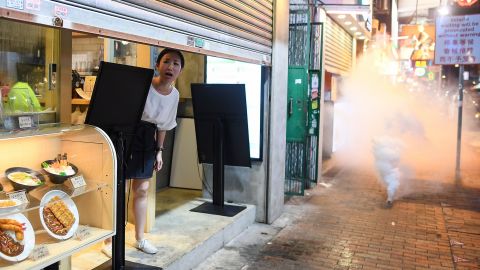 A woman reacts as police personnel fire tear-gas shells to disperse pro-democracy protestors in the Sham Shui Po Area of Hong Kong on August 14, 2019.