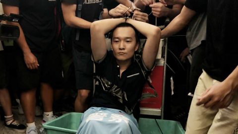 Global Times reporter Fu Guohao, who was suspected of being a Chinese spy, is tied up by protesters at the Hong Kong International Airport during a demonstration on August 13, 2019.