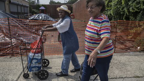 Lorraine Macklin, left, and Edith Tappins pick up bottled water in Newark.
