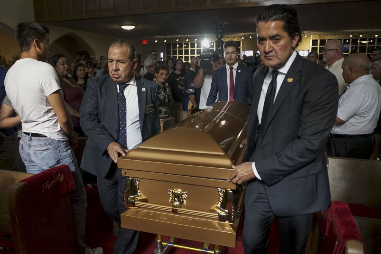 Pallbearers carry Reckard's casket into a public memorial. Hundreds of people packed into the La Paz Faith Memorial and Spiritual Center in El Paso to attend the service.