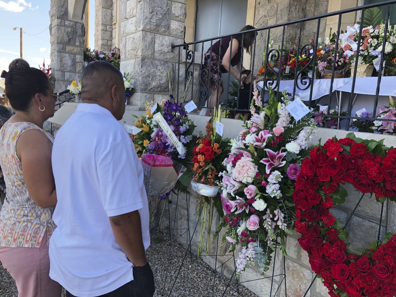 People deliver flowers for Reckard's funeral and memorial services. 