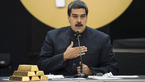 Nicolas Maduro speaks next to a stack of gold ingots during a news conference on the country's cryptocurrency, known as the Petro, in Caracas, Venezuela on March 22, 2018. 