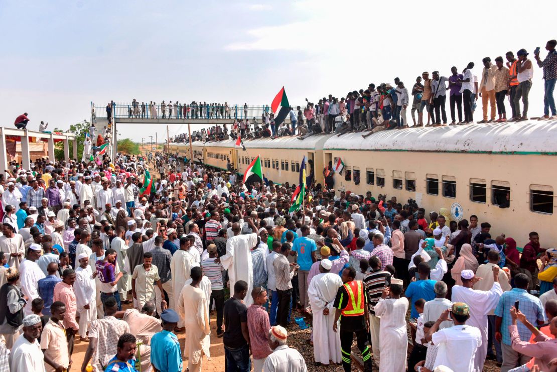 Sudanese protesters from the city of Atbara arrive in Khartoum to celebrate transition to civilian rule.
