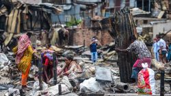 Residents search for household belongings in a slum in Dhaka on August 18, 2019, after a fire broke out late on August 17 at Mirpur neighbourhood. - At least 10,000 people are homeless after a massive fire swept through a crowded slum in the Bangladesh capital and destroyed thousands of shanties, officials said on August 18. (Photo by MUNIR UZ ZAMAN / AFP)        (Photo credit should read MUNIR UZ ZAMAN/AFP/Getty Images)