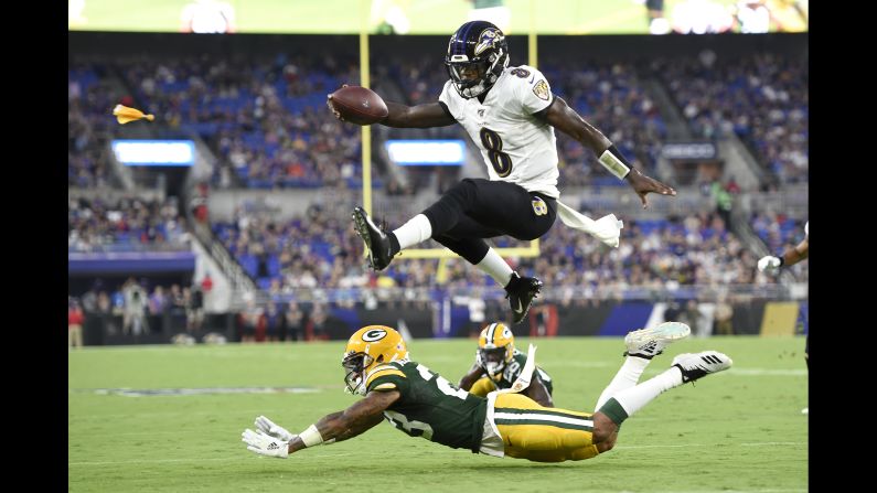 Baltimore Ravens quarterback Lamar Jackson hurdles over Green Bay Packers cornerback Jaire Alexander during the first half of a NFL preseason football game in Baltimore on Thursday, August 15.