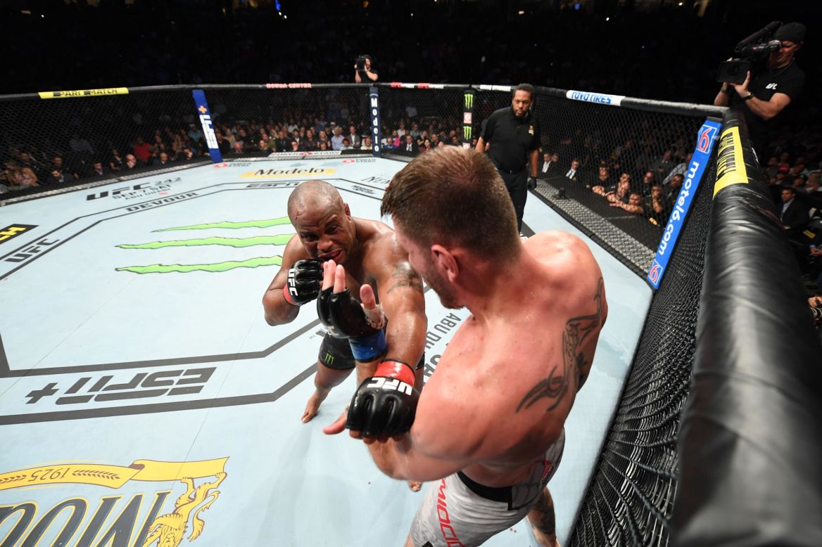 Daniel Cormier punches Stipe Miocic during their <a href="https://bleacherreport.com/articles/2850076-stipe-miocic-stuns-daniel-cormier-wins-ufc-heavyweight-title-via-knockout?utm_source=cnn.com" target="_blank" target="_blank">UFC heavyweight championship fight</a> at the Honda Center in Anaheim, California, on Saturday, August 17. Miocic won the fight via fourth-round knockout.