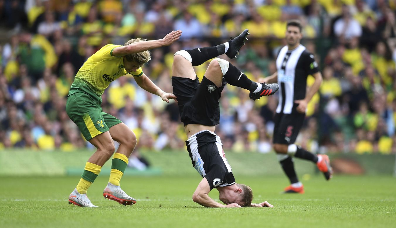 Norwich City's Todd Cantwell, left, tackles Newcastle United's Emil Krafth during an English Premier League soccer match between Norwich City and Newcastle United in Norwich, England, on Saturday, August 17.