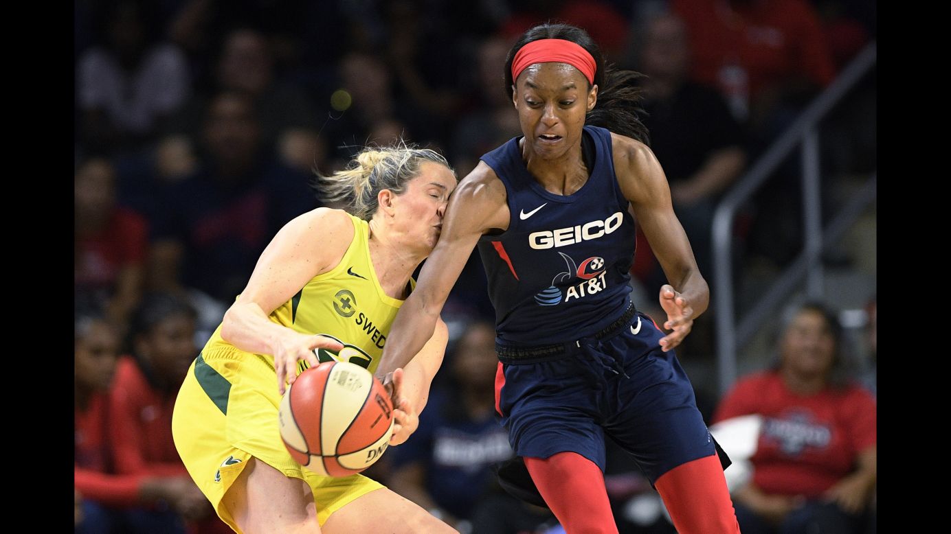 Washington Mystics guard Shatori Walker-Kimbrough, right, attempts to steal the ball from Seattle Storm guard Sami Whitcomb during the second half of a WNBA basketball game in Washington D.C., on Wednesday, August 14.