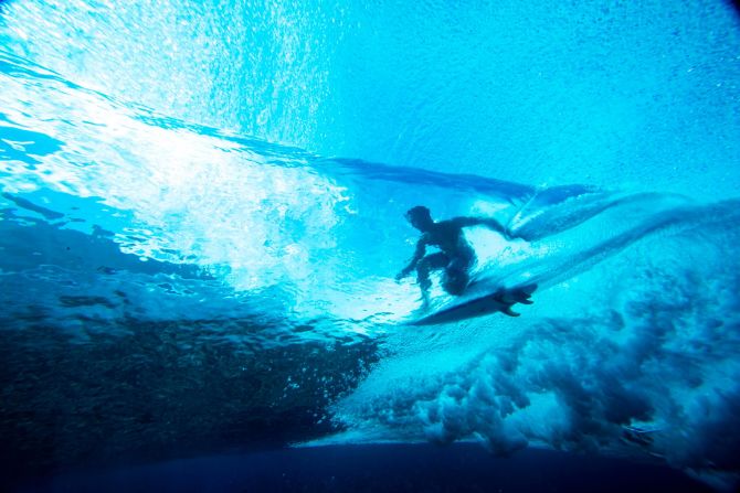 Taumata Puhetini from Tahiti rides a wave during practice for the Tahiti pro trials surf competition on August 15.