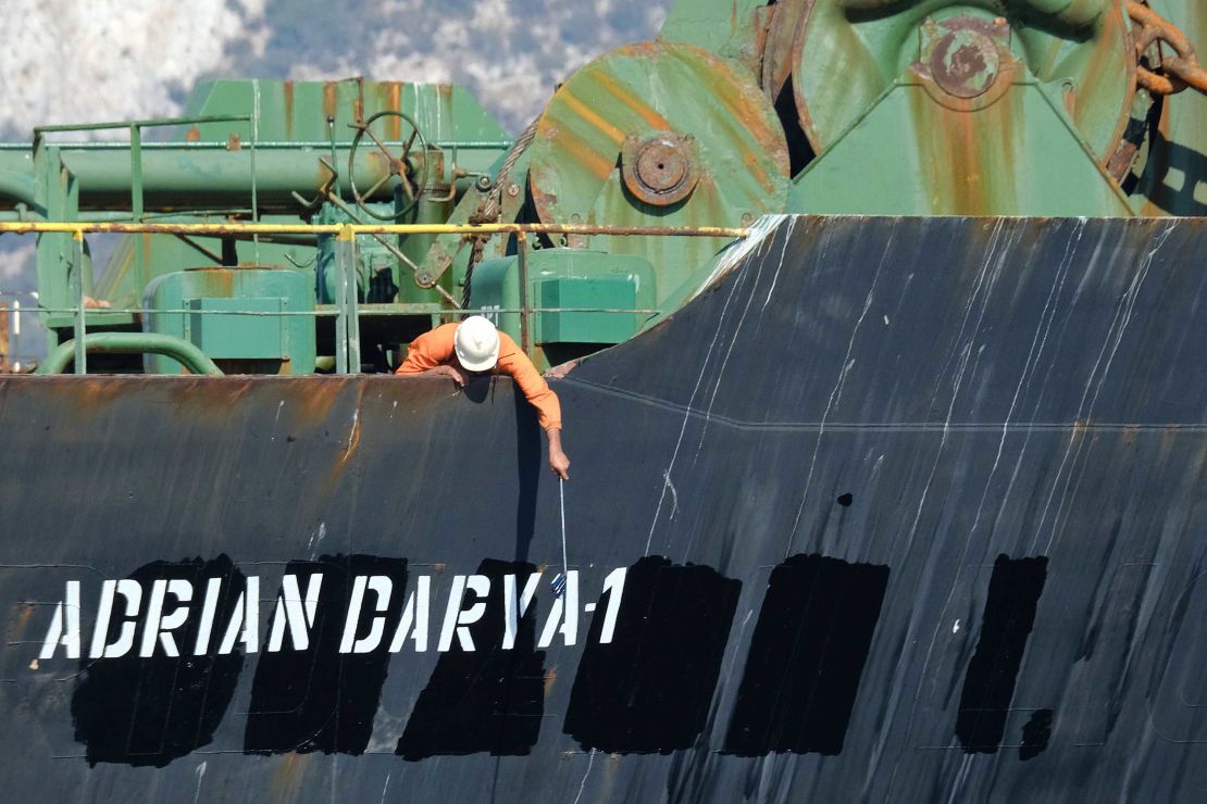 A crew member checks the new name of Iranian oil tanker Adrian Darya, formerly known as Grace 1.