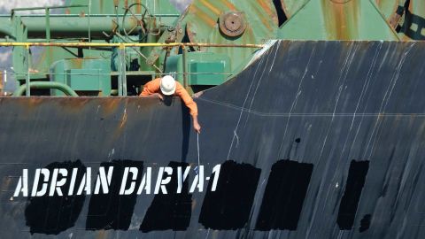 A crew member checks the new name of Iranian oil tanker Adrian Darya, formerly known as Grace 1.