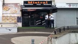 Policemen stand in front of the eatery where a waiter was shot dead by a customer allegedly angry at having to wait for a sandwich, in the eastern Paris suburb of Noisy-le-Grand on August 17, 2019. - The gunman, who witnesses said lost his temper "as his sandwich wasn't prepared quickly enough" for his liking, fled the scene. Police have opened a murder investigation. (Photo by Tiphaine LE LIBOUX / AFP)        (Photo credit should read TIPHAINE LE LIBOUX/AFP/Getty Images)